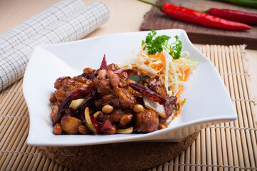 Kung Pao chicken, also transcribed Gong Bao or Kung Po, is a spicy, stir-fried Chinese dish made with cubes of chicken, peanuts, vegetables, and chili peppers. 