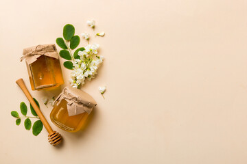 honey jar with acacia flowers and leaves. fresh honey top view flat lay