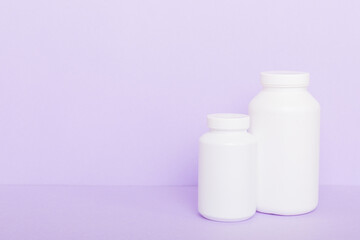 supplement pills with medicine bottle health care and medical top view. Vitamin tablets. Top view mockup bottle for pills and vitamins with green leaves, natural organic bio supplement, copy space