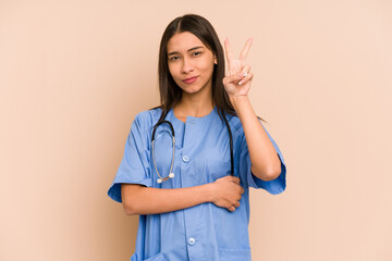 Young nurse colombian woman isolated showing number two with fingers.