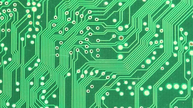 Simple green PCB circuit board lines from above, abstract background texture, nobody, no people, pan right, top down view. Computer technology backdrop, tech backgrounds, electronics and engineering