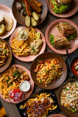 Vertical photo various of food on cafe table. Italian, american food platesm junk and snack food. Top view, full frame