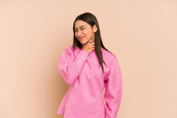Young colombian woman isolated on beige background touching back of head, thinking and making a...