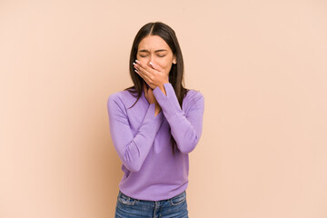 Young colombian woman isolated on beige background suffers pain in throat due a virus or infection.