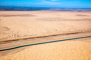 Aerial view looking SW from the All American Canal in California at the Imperial Sand Dunes and the U.S.-Mexico border wall