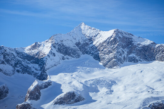 The mountains, glaciers and snow of Val Malenco, during a sunny winter day, near the village of Chiesa in Valmalenco, Italy - December 2022.