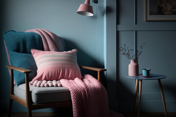 A wooden lamp is placed next to a bed that is covered in blue blankets and has a grey armchair and a pink wall. Generative AI
