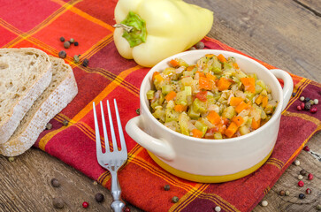 Bowl with hot vegetable stew served on a table