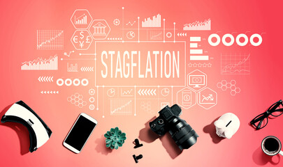 Stagflation theme with electronic gadgets and office supplies - flat lay