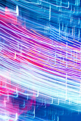 Abstract blurred bokeh neon light trails city night background