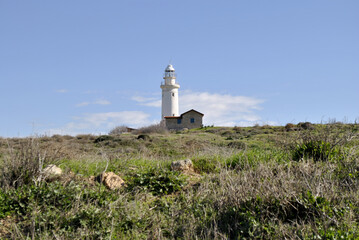 Fototapeta na wymiar Lighthouse on the green hill