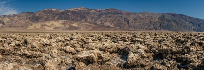 Wrinkle, dry ground Badwater basin with mountains backround in Death Valley national park