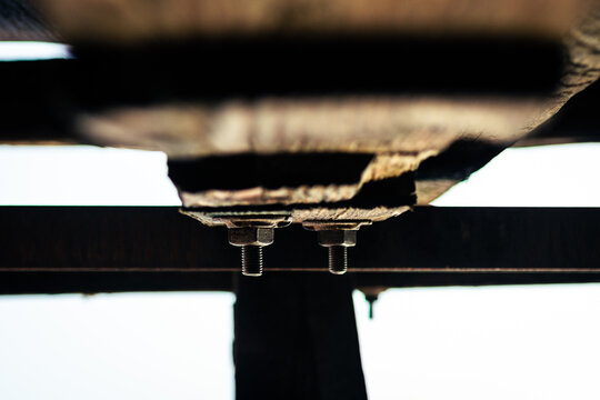 Detailed shot of two rusty screws in wooden beams construction