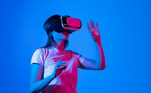Brunette woman architect or engineer wearing VR headset for working design 3D architectural model in virtual reality space.