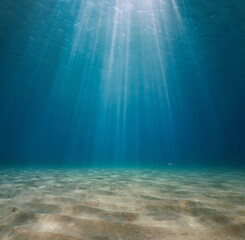 Fototapeta na wymiar Rays of sunlight underwater with a sandy seabed in the Mediterranean sea, Spain