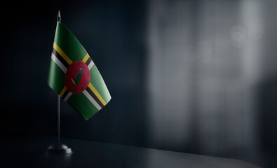 Small national flag of the Dominica on a black background