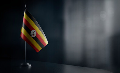 Small national flag of the Uganda on a black background