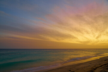 Naklejka na ściany i meble A colorful sunset on the Atlantic coast on the island of Sal in Cape Verde.