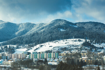Fototapeta na wymiar View of a town in winter season.Beautiful snowy mountains in background.