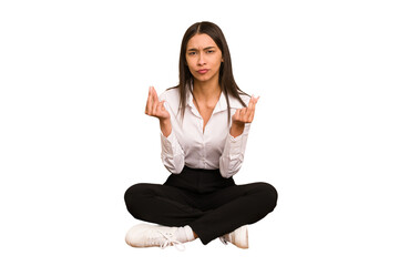Young colombian woman sitting on the floor isolated showing that she has no money.