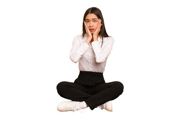 Young colombian woman sitting on the floor isolated whining and crying disconsolately.