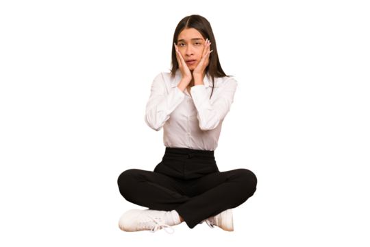 Young colombian woman sitting on the floor isolated whining and crying disconsolately.