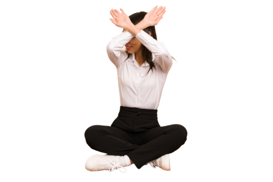 Young colombian woman sitting on the floor isolated keeping two arms crossed, denial concept.