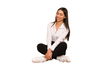 Young colombian woman sitting on the floor isolated cut out