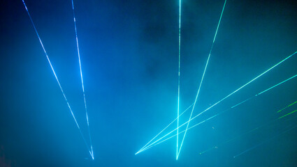 Laser show. Night club, lights, smoke machine. Blue background