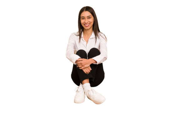 Young colombian woman sitting on the floor isolated cut out