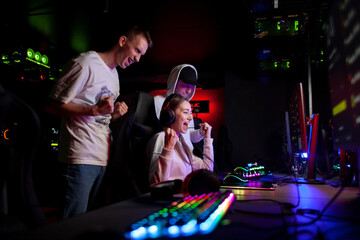 esports team rejoice in victory in computer club and shout at monitor, gamers play together