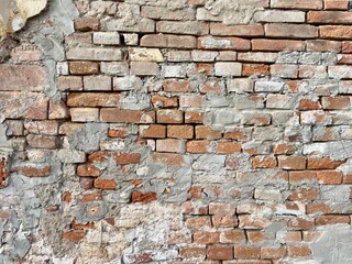 Vintage cracked bricks wall with cements texture. Bricks urban background