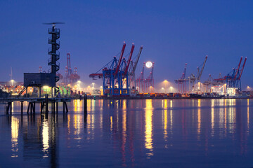 harbor at night with cranes 