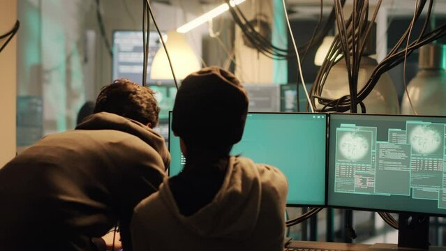 Male hacker using knowledge of computer science to access important data illegally, breaking into network system or server. Thief doing cryptojacking and espionage with virus.