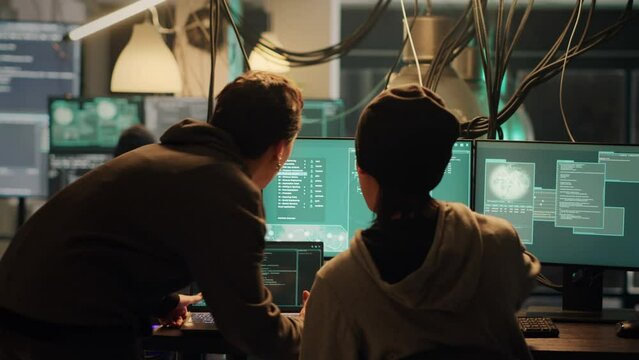 Young criminal using knowledge of technology to access valuable information illegally, breaking into computer system or network. Spy doing cryptojacking and espionage with virus.