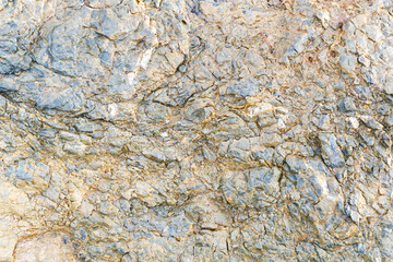 Mineral rock texture. Grainy geology surface. Color marble pattern. Rusty noise background. Vintage grunge backdrop. Sea shore rock texture.