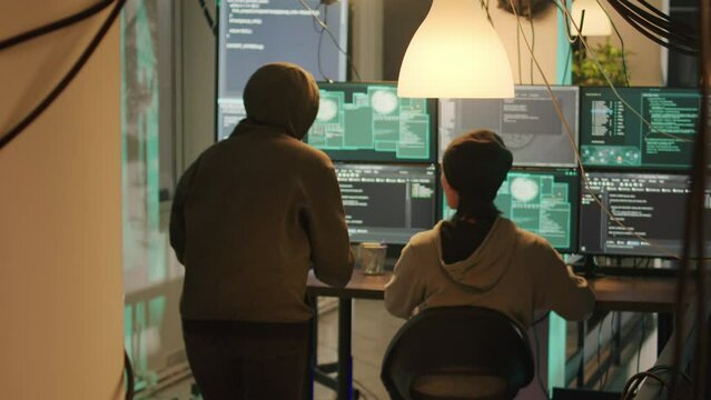 Team of cyber spies looking at firewall encryption to break network system illegally, making cryptojacking attack. Diverse hackers working on online espionage, doing identity theft.