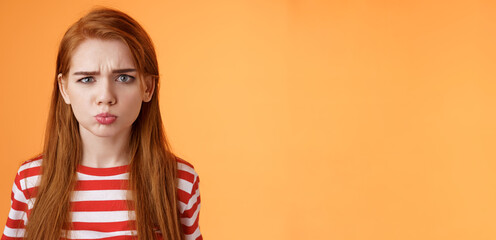 Childish offended cute redhead girl pouting, sulking upset, frowning, complain unfair situation,...
