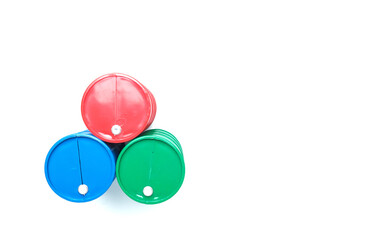 Flatlay picture of oil blue, green and red oil barrels combine on white background.