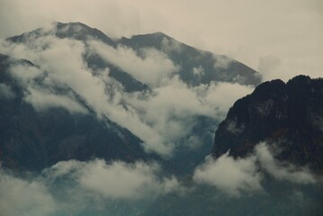 Fascinating view of the Swiss mountains and forests, which are covered with fog similar to the clouds that covered the forest.