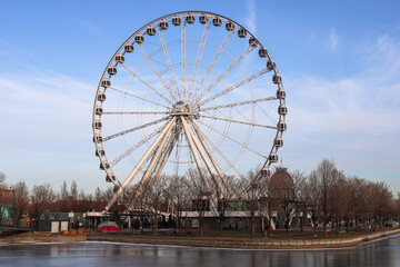 Montreal tourism - ferris wheel, details, on  blue sky background. Amusement park, festive mood. viewpoint