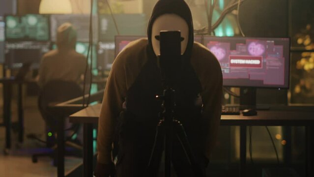 Thief using hacking techniques to steal valuable data and receive ransom instead of leaking information. Broadcasting live threat on smartphone, network security breach and cybercrime.