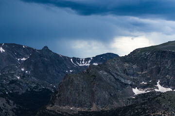 Snowy mountains surrounded by trees and rolling hills in Rocky Mountain National Park 
