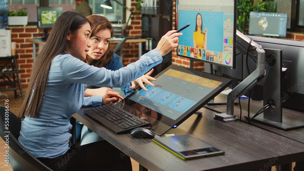 Poster color grading editors retouching professional photos with editing software and stylus, working on mu
