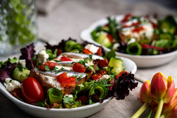 Toasted baguette, white anchovies, goat cheese, and chopped tomato. Served on mixed greens with shaved cucumber and garnished with fresh parsley.
