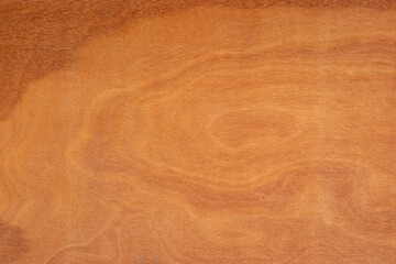 Plywood dark yellowish orange and has a wood pattern like a water wave.