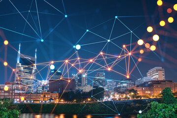 Panoramic view of Broadway district of Nashville over Cumberland River at illuminated night skyline, Tennessee, USA. Social media icons. The concept of networking and establishing people connections