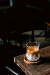 Dirty Coffee - A glass of espresso shot mixed with cold fresh milk in coffee shop cafe and restaurant