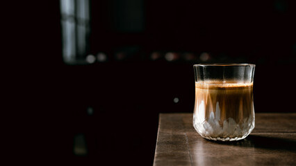 Dirty Coffee - A glass of espresso shot mixed with cold fresh milk in coffee shop cafe and restaurant