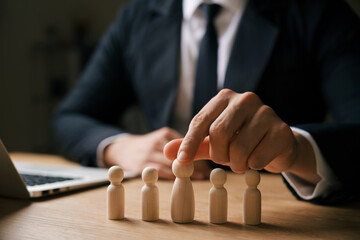 Teamwork concept, wooden dolls and wooden blocks show leadership. Work together for goals for the future.